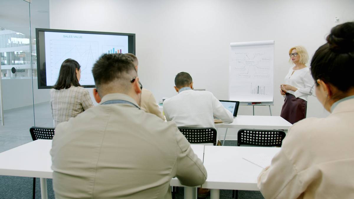 Team engaging with interactive compliance training courses dashboard showing real-time decision analytics